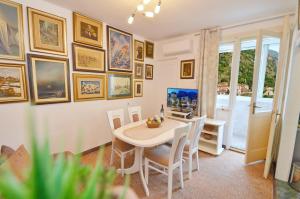 a dining room with a table and chairs at Central Art Oasis Kotor in Kotor