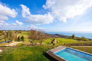 a view of the ocean from a house with a swimming pool at BlackSeaRama Golf & Villas in Balchik