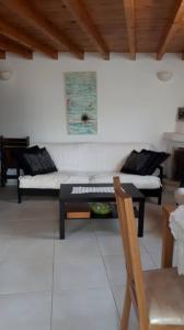 a living room with a couch and a table at Katerina's traditional house in lefkes village in Lefkes