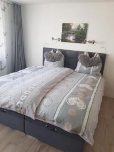 a bed in a bedroom with a blue bed frame at Mosel-Ina in Bullay