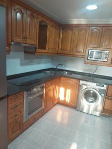 a kitchen with a sink and a washing machine at Haitze in Getaria