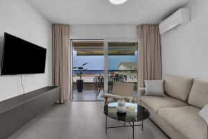 a living room with a couch and a television at Apartment Lea - Makarska Exklusiv in Tučepi