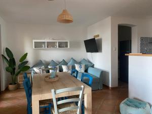 a living room with a table and a couch at Sunshine House in Porto Pino