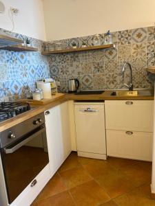 a kitchen with a sink and a stove top oven at Sunshine House in Porto Pino