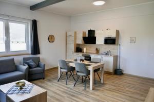 a living room with a table and chairs and a couch at Ferienwohnungen Büffel in Heimbach