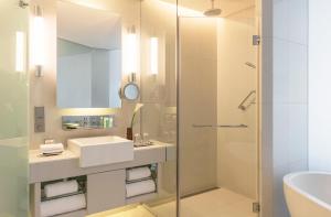 a bathroom with a sink and a shower at The Westin City Centre Bahrain in Manama