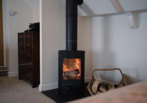 Ein Ofen in der Ecke eines Wohnzimmers mit Kamin in der Unterkunft The Bear, Cowbridge in Cowbridge + 18 Fotos