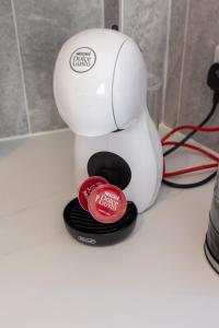 a white coffee maker sitting on top of a counter at Flatzy - 16 Guests 4 En-suite Central Apartment B in Liverpool