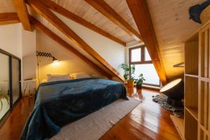 a bedroom with a bed in a room with wooden ceilings at Just 4 You in Komiža