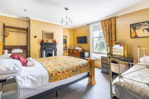a bedroom with a bed and a window at Penyvoel Hall in Llanymynech