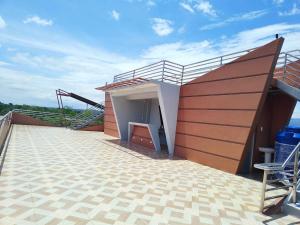 a building with a patio with a chair on it at RNEK Boatel Commercial Space in Moalboal