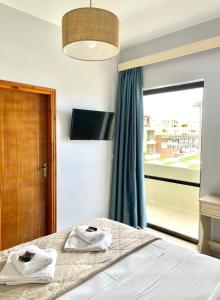 1 dormitorio con 1 cama con toallas en wave rooms sea view, en La Canea