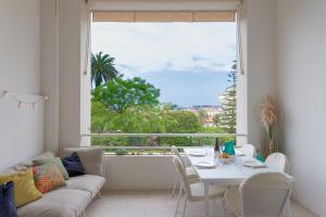 a living room with a table and a large window at Alma Gallia 4 pers in Cannes