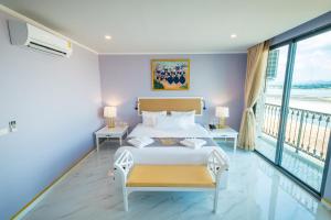 Posteľ alebo postele v izbe v ubytovaní Mekong Heritage Hotel