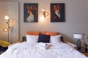 a bedroom with a bed with two paintings on the wall at Alma Gallia 4 pers in Cannes