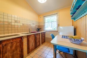 a kitchen with a table with a bowl of fruit on it at Camping KamA in Mikołajki