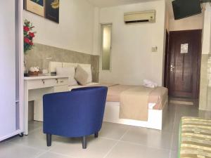 a bedroom with a bed and a desk and a blue chair at SaiGon CoZy Hotel "241 Pham Ngu Lao Street'' in Ho Chi Minh City