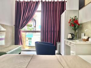 Postel nebo postele na pokoji v ubytování SaiGon CoZy Hotel "241 Pham Ngu Lao Street''