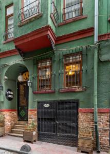 a green building with windows and a door at Istanbul Irish Hotel in Istanbul