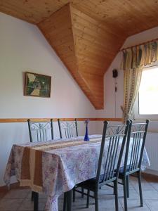 a dining room table with chairs and a table cloth at Balaton White House in Vonyarcvashegy