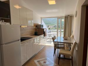 a kitchen with a table and a dining room at Apartments Ana in Stari Grad