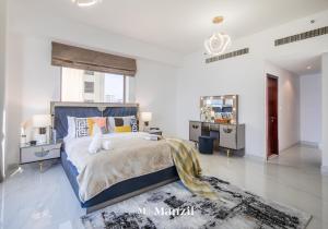 a bedroom with a bed with a stuffed animal on it at Manzil - Lavish 3BR in JBR with Sea Views and 5 min walk to beach in Dubai