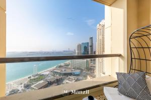 a view of the ocean from a balcony of a building at Manzil - Lavish 3BR in JBR with Sea Views and 5 min walk to beach in Dubai