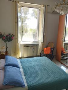 a bedroom with a large bed with a large window at Casa Nonna Anna in Genoa