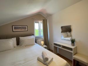 a bedroom with a bed and a window at Apartments Ana in Stari Grad