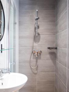 a bathroom with a shower and a sink at Willa MM Kaszuby in Łapalice