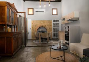 a living room with a table and a kitchen at Colours - Old Town - Studio in Rhodes Town