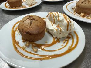 a plate with a muffin and ice cream on it at Maison d'Hôtes Zella in Bains de Guitera