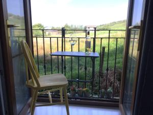 a table and a chair on a balcony at 2 Double Rooms-Sleeps 4- 2 Bathrooms in Rossendale