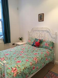 Rossendaleにある2 Double Rooms-Sleeps 4- 2 Bathroomsの子供が緑の掛け布団を使用してベッドに寝そべる
