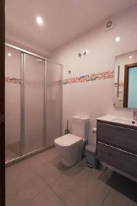 a bathroom with a toilet and a shower and a sink at Blanca Boutique BnB in Jávea
