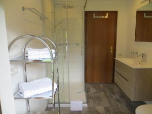 a bathroom with a shower and a sink with towels at Zani Helga in Schruns