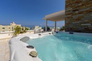 a hot tub on the roof of a building at Fig Tree Bay Residences 6 in Protaras