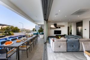 a living room with a table and a couch at Fig Tree Bay Residences 6 in Protaras