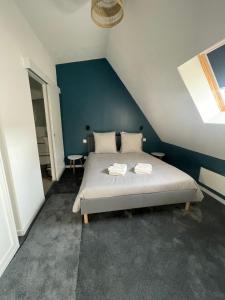 a bedroom with a bed with two towels on it at Résidence la Chevalerie in Bayeux