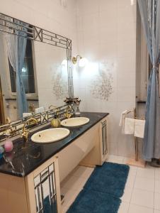 a bathroom with two sinks and a large mirror at Casa Nonna Anna in Genoa