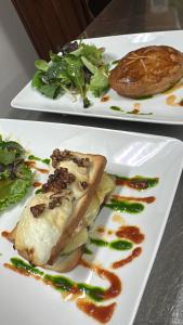 two white plates with food on top at Maison d'Hôtes Zella in Bains de Guitera