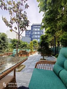 a park with benches and a building in the background at Porta Romanos Hotel in Istanbul