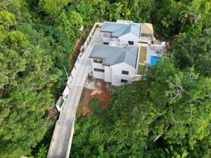 an aerial view of a house in the forest at RIVERSIDE RETREAT (SEYCHELLES) in Mahe