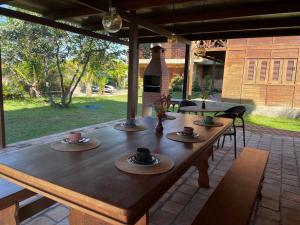 a wooden table with cups on top of it on a patio at Atins Bangalôs in Atins