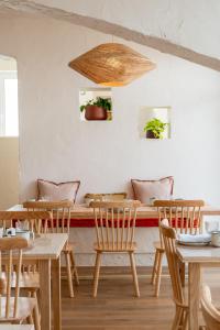 a dining room with wooden tables and chairs at Praia FLH Hotels Ericeira in Ericeira
