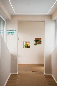 a room with two pictures on the wall at Praia FLH Hotels Ericeira in Ericeira