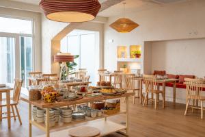 a room with a table with food on it at Praia FLH Hotels Ericeira in Ericeira