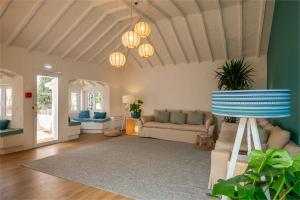 a living room with a couch and chandeliers at Praia FLH Hotels Ericeira in Ericeira