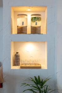 a shelf with glasses and a bottle on it at Praia FLH Hotels Ericeira in Ericeira