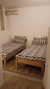 two beds sitting next to each other in a room at Apartment Ami in Trebinje +7 photos